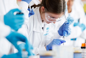 A photograph of students in Temple Carrig School in Greystones Co. Dublin wearing a lab coat and science goggles practicing micro pipetting skills as part of the Amgen Biotech Experience One Million Students Celebration in 2024